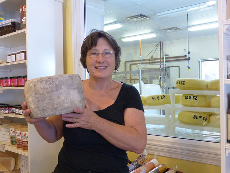Debra Amrein-Boyes, cheese maker and co-owner of The Farm House Natural Cheeses, with her award-winning traditional Clothbound Cheddar