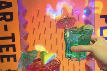 two festive beverages with umbrellas
