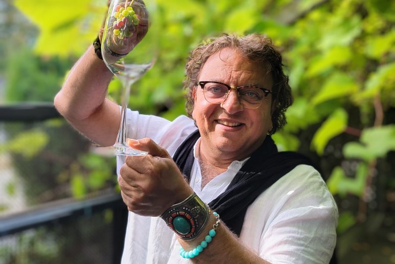 Chef Vikram Vij with Grapes and a Wine Glass